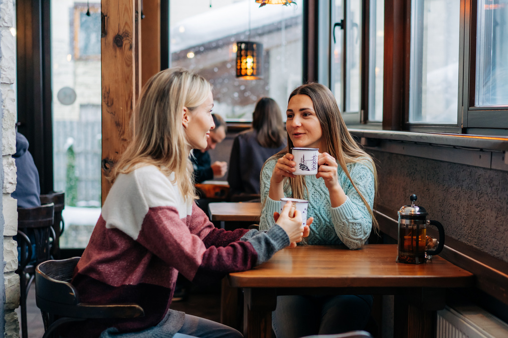 Women Drink Coffee in a Café 